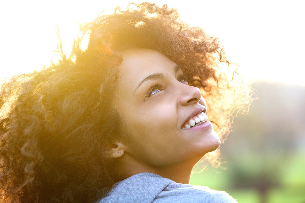 black woman with lash extensions outdoors in the sunshine