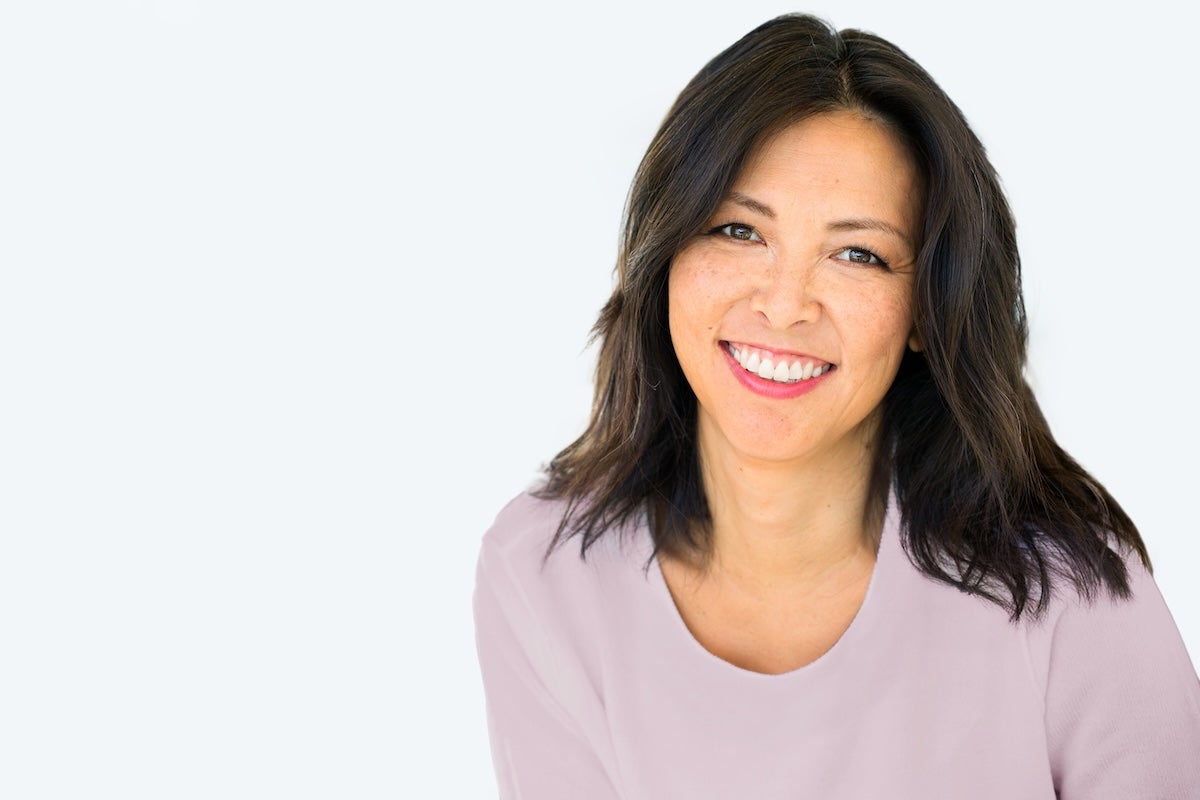 mid-shot of woman smiling with a lash tint