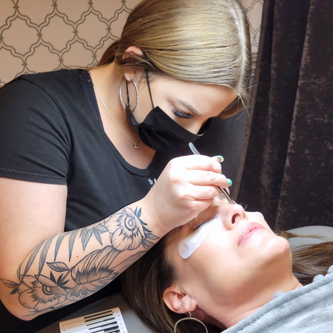 lash stylist applying lash extensions on a guest