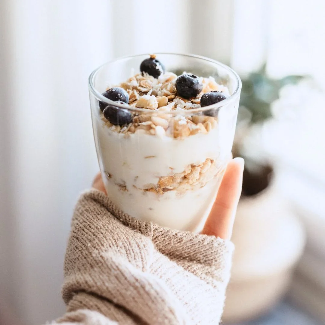 hand holding a yogurt parfait