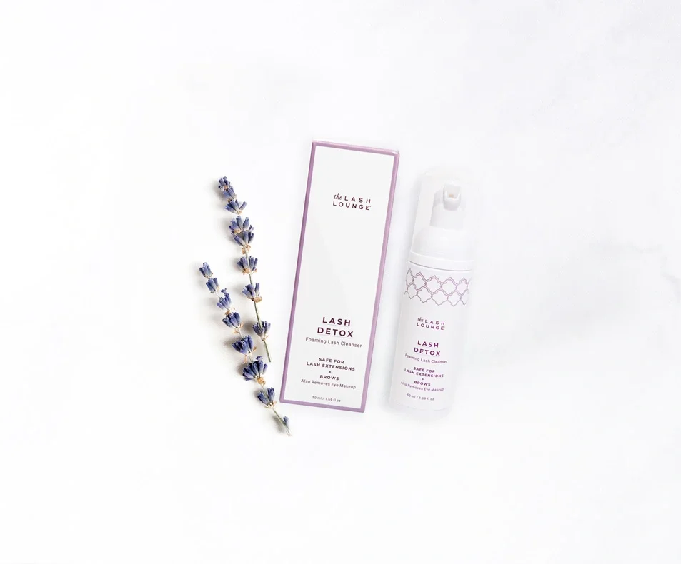 The Lash Lounge’s Unscented Lash Detox foaming cleansers lying on a marble counter.