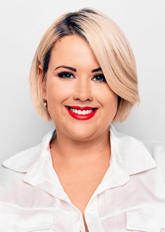 close-up of smiling woman with short blonde hair and lash extensions