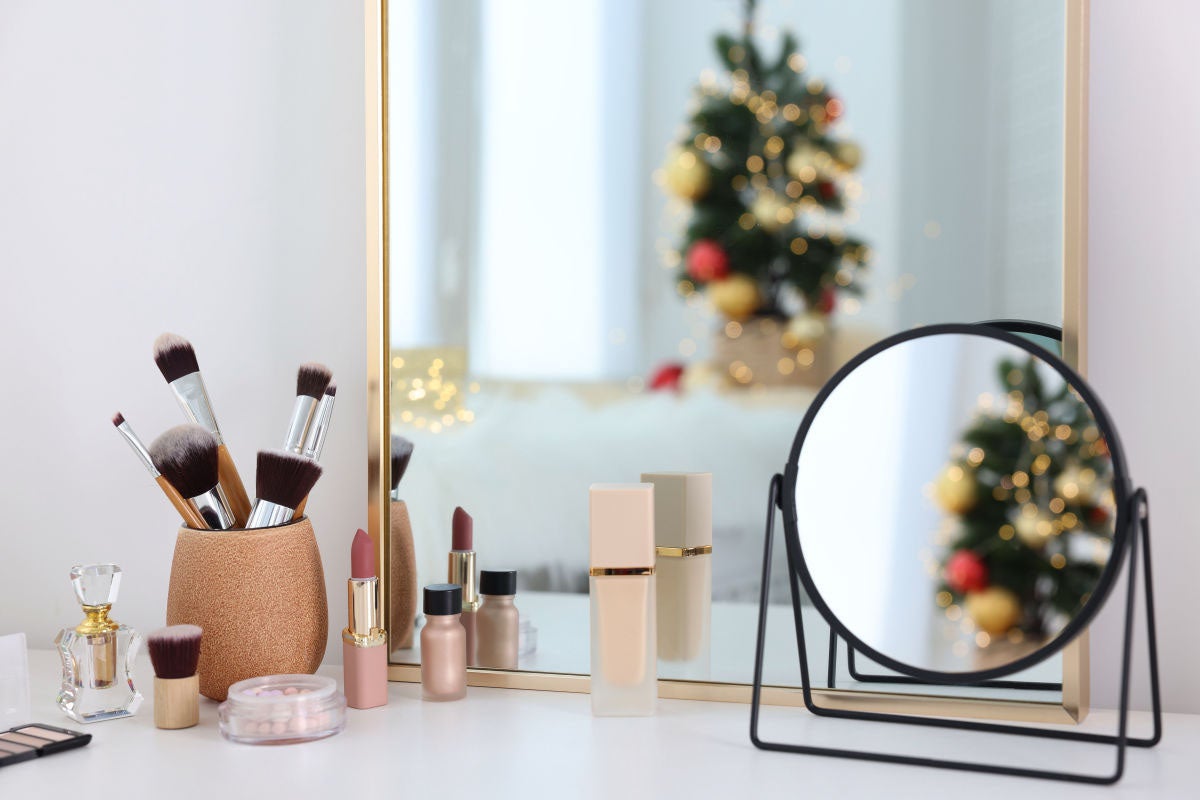 Makeup and small mirror on a white table