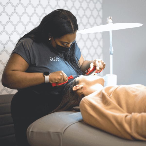 woman getting eyebrow threading service done