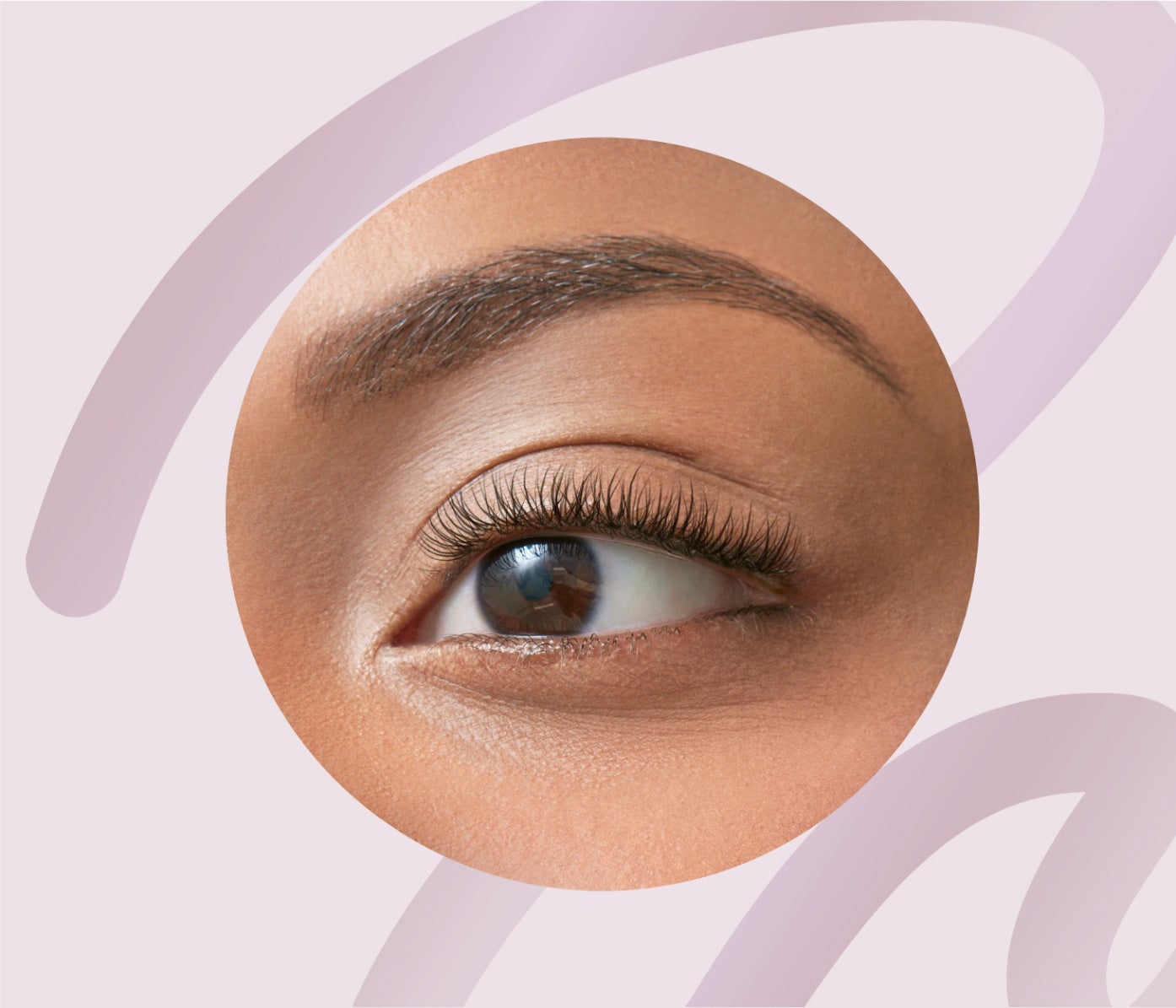 Close-up of a woman's eye with expertly tinted eyelashes and eyebrows at The Lash Lounge, enhancing natural color and definition.