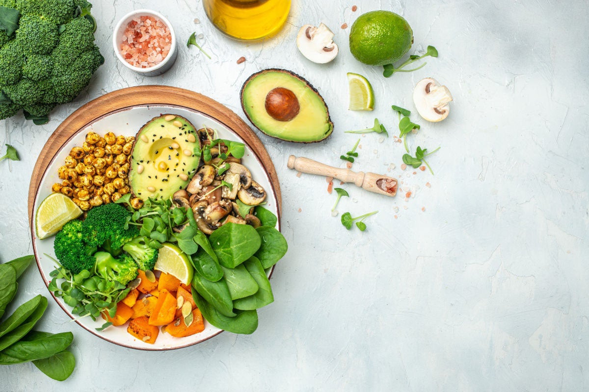 bowl with avocados and veggies on grey surface