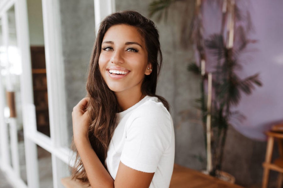 Young brunette woman with a spray tan and lash extensions