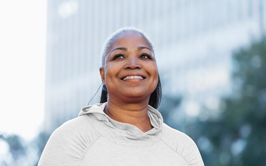 mature black woman with lash extensions outdoors in city