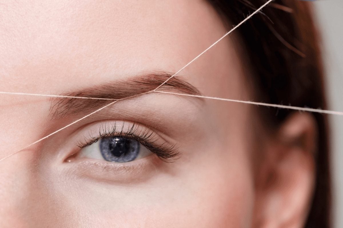 close-up of woman during brow threading