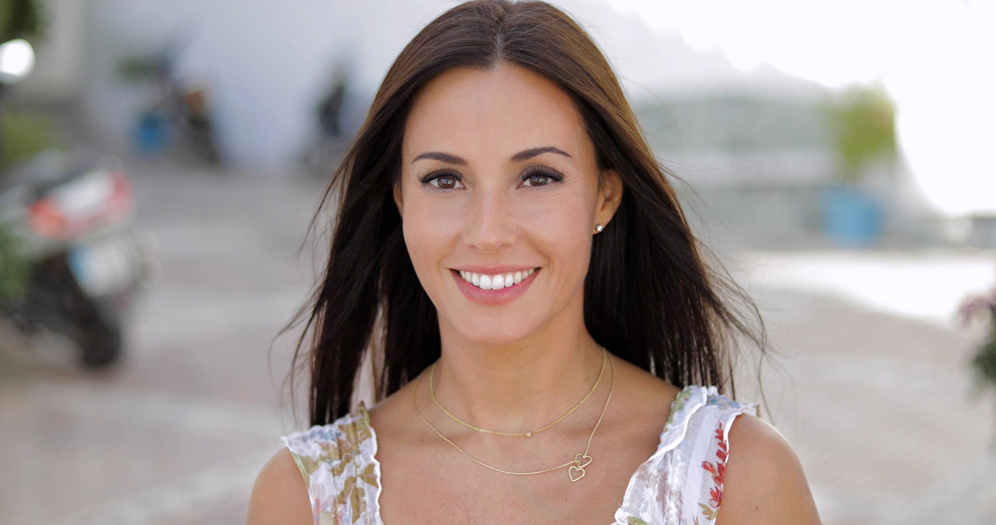 Woman smiling outside and wearing makeup for a wedding