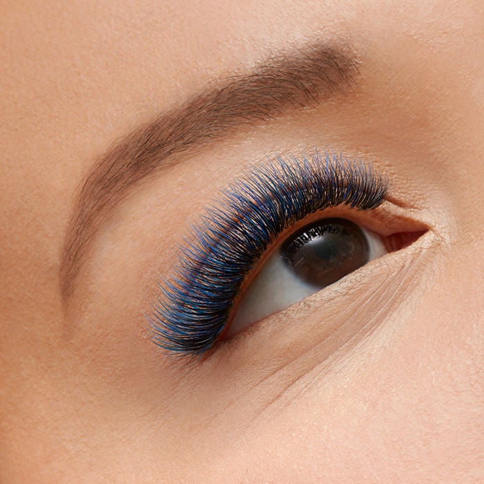 close-up of woman's eye with blue lashes