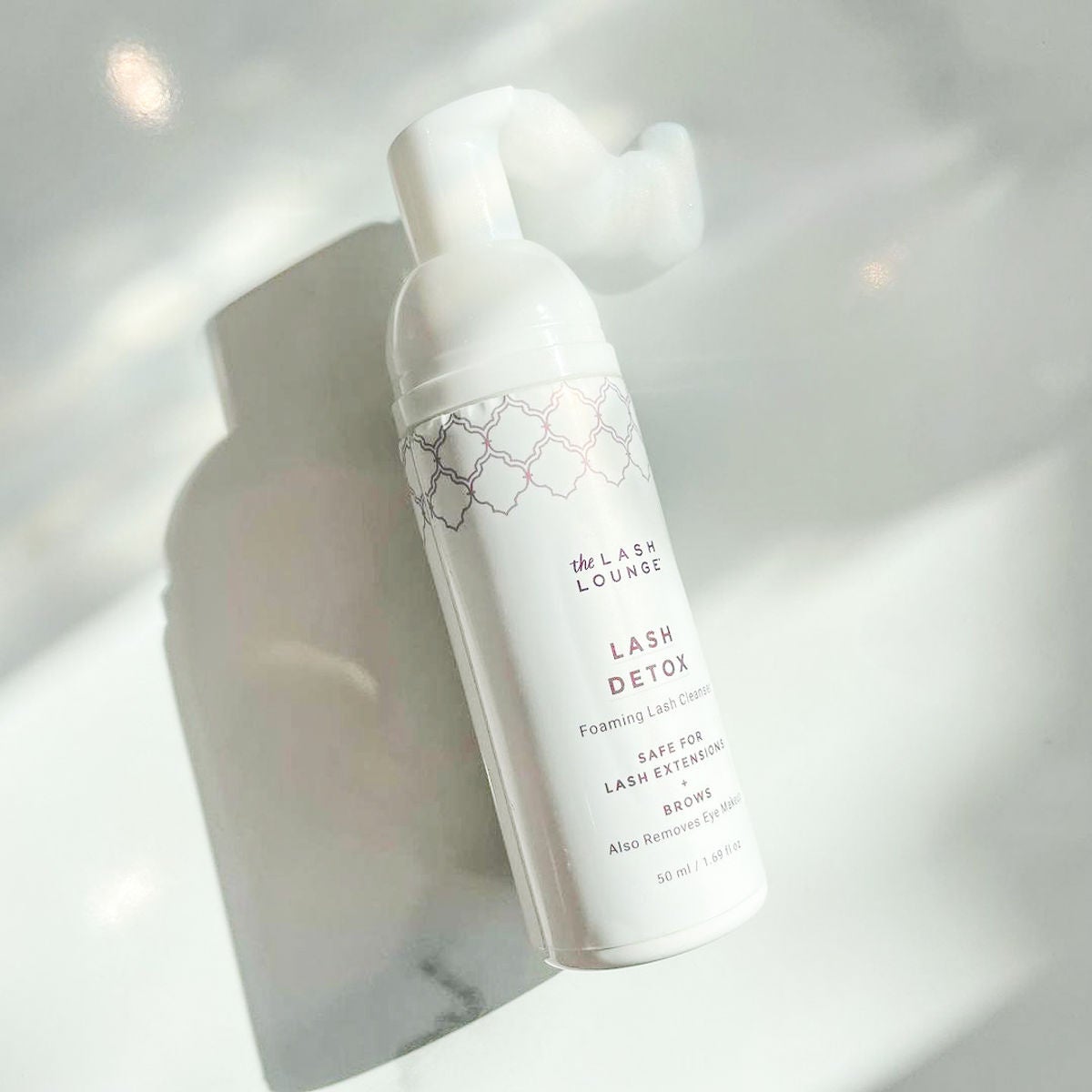 The Lash Lounge's Detox Foaming Cleanser on marble counter.