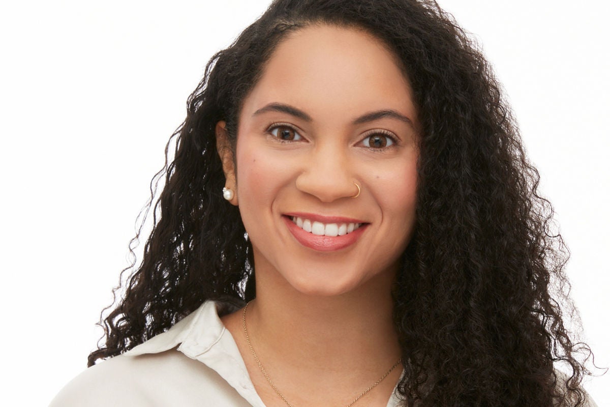 mid-shot of woman smiling with tinted eyebrows