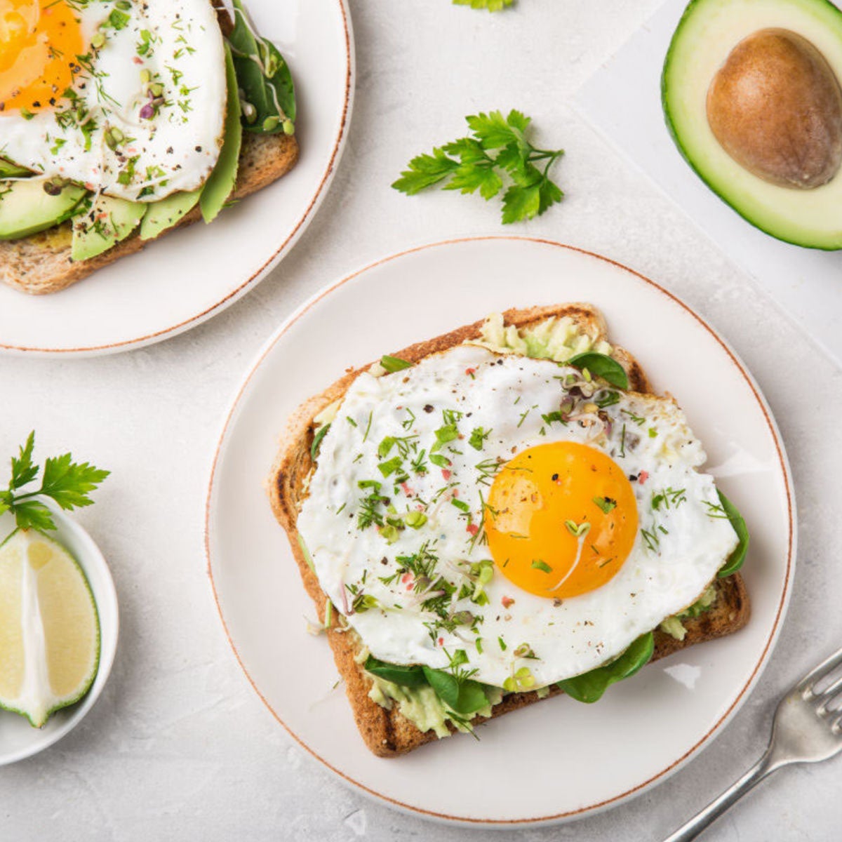 white plate with breakfast avocado and egg toast