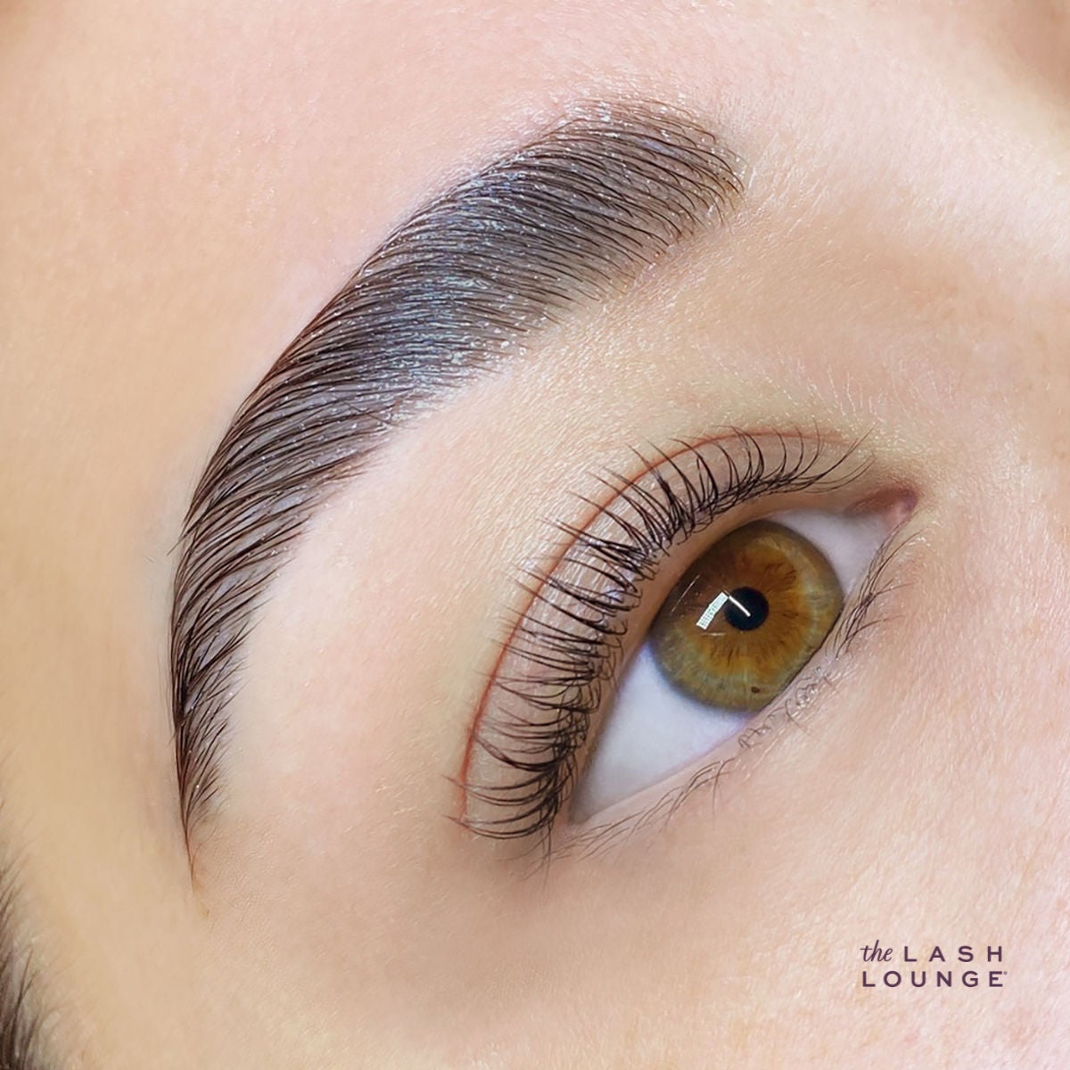 extreme close-up of white woman's eye with lash lift, tint and brow lamination