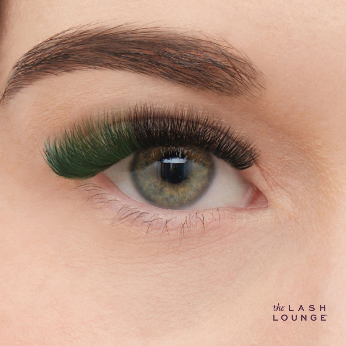 close-up of woman's eye with green color pop lash extensions